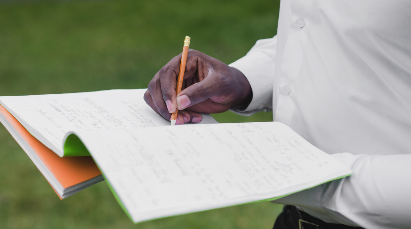 5 Things to Check Before Buying Land man holding notebooks writing