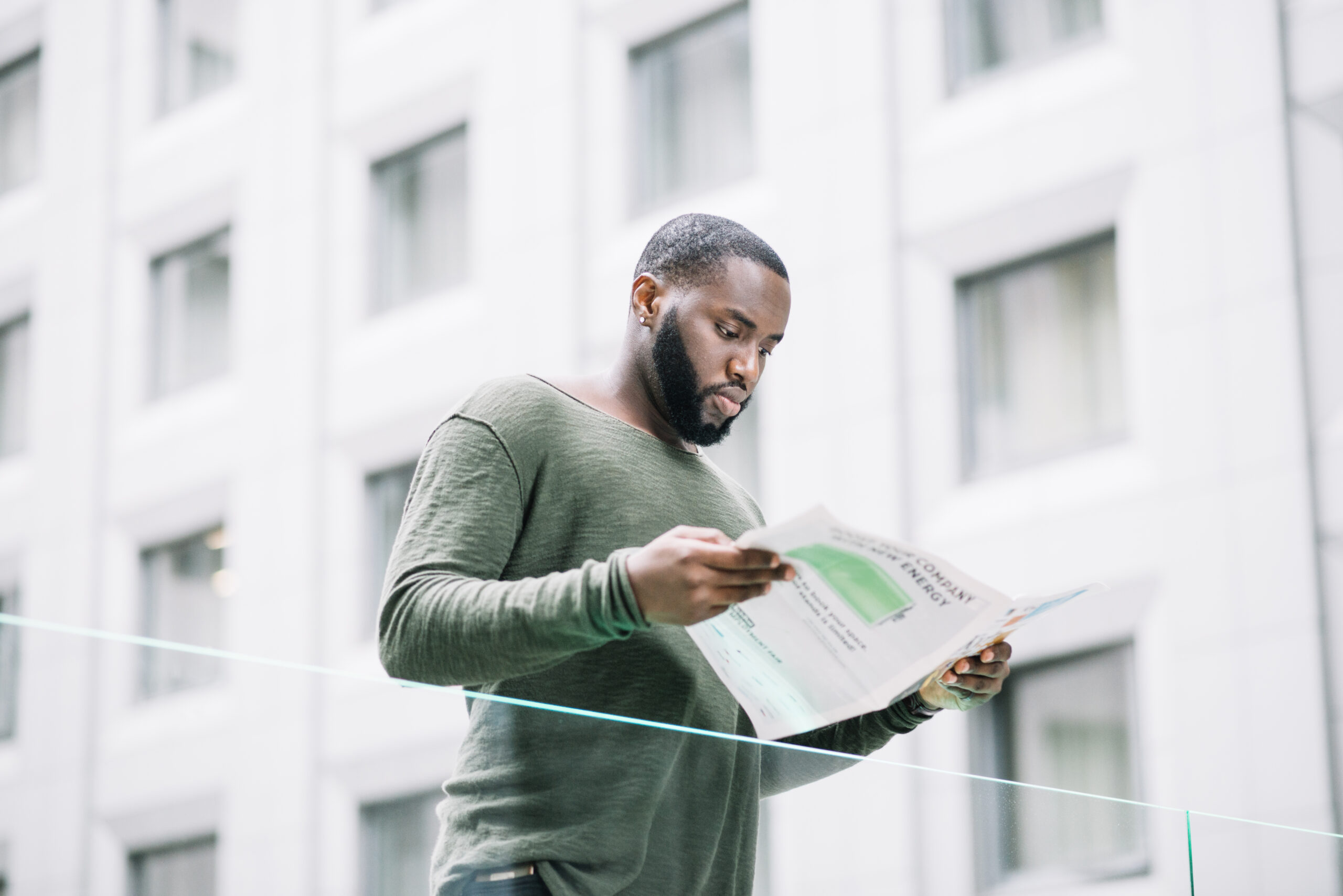 The 6-Month Difference: Why Buying Today Costs Less Than Waiting man reading newspaper near glass fence